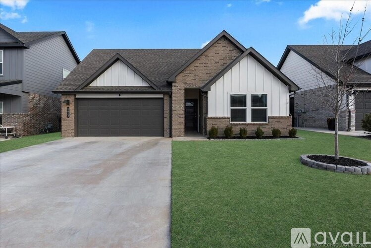 A house with a garage and a driveway in front.