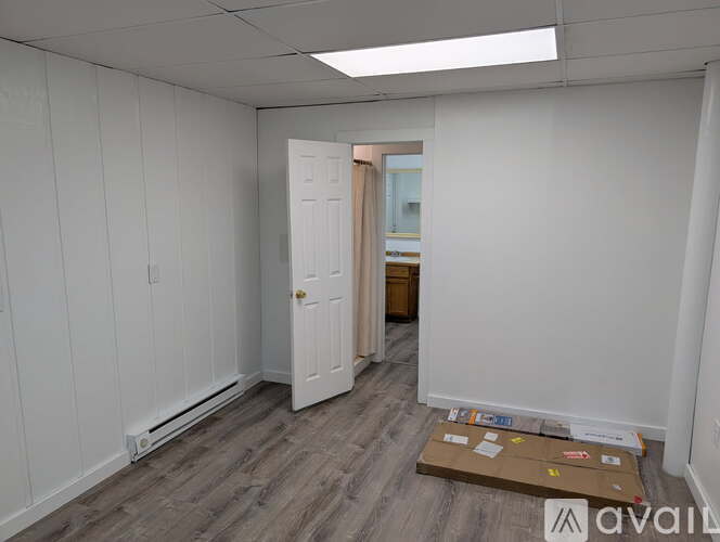 A room with a door and a box on the floor.