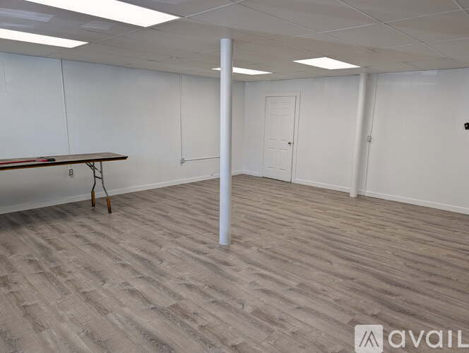 A room with a long table and a white door.