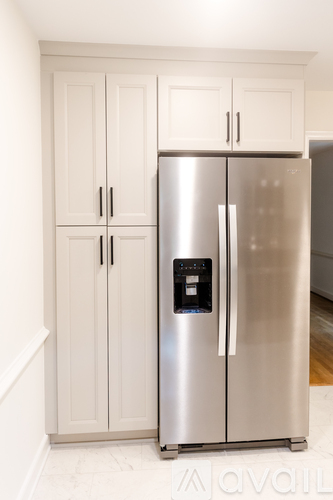 A stainless steel refrigerator with a water and ice dispenser in the middle of the door.