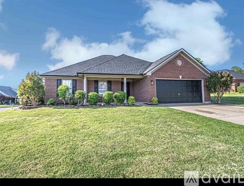 A house with a garage and a driveway in front.