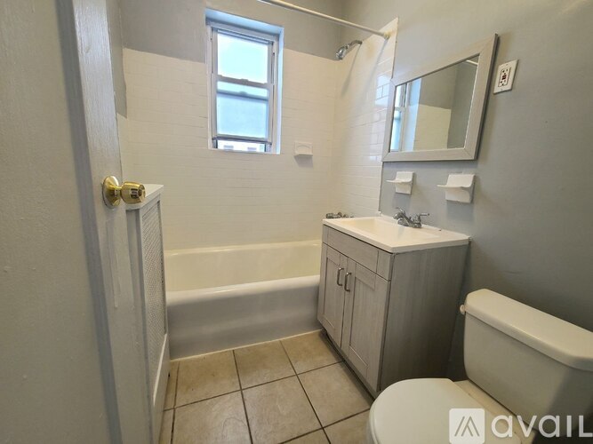 A bathroom with a toilet, sink, and bathtub.