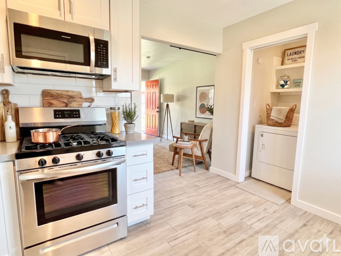 A kitchen with a stove top oven and a microwave above it.