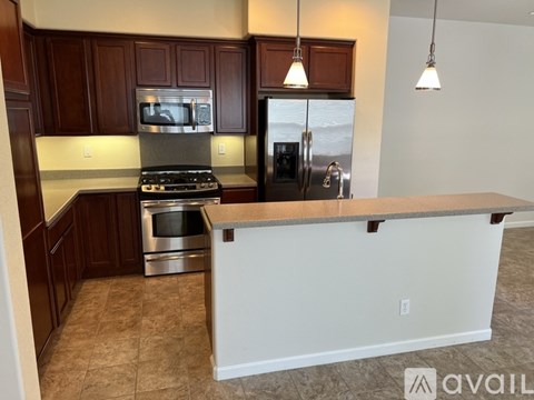 A kitchen with a white counter and a refrigerator.