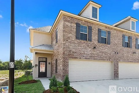 A house with a garage and a driveway in front.