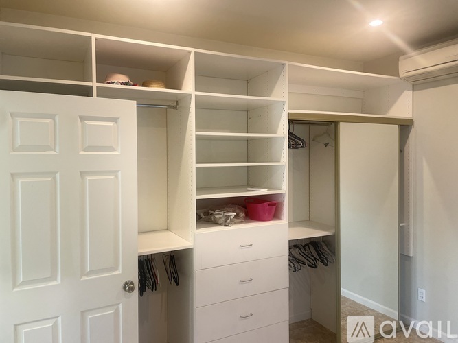 A white closet with drawers and shelves.