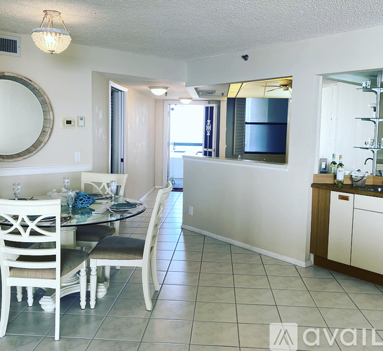 A kitchen with a dining table and chairs.
