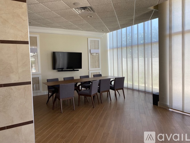 A modern dining room with a wooden table and chairs.