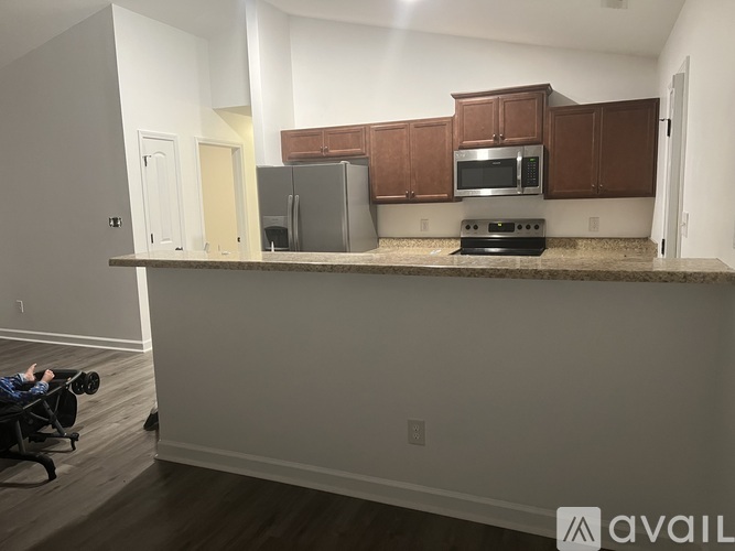 A kitchen with brown cabinets and a countertop.