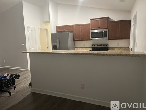 A kitchen with brown cabinets and a countertop.