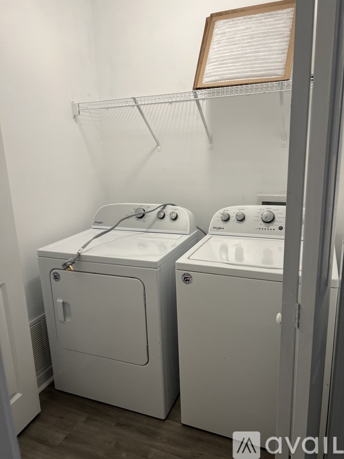 A small laundry room with two washing machines.