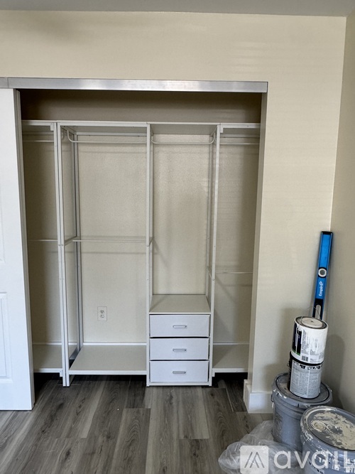 A white closet with a shelf and drawers.