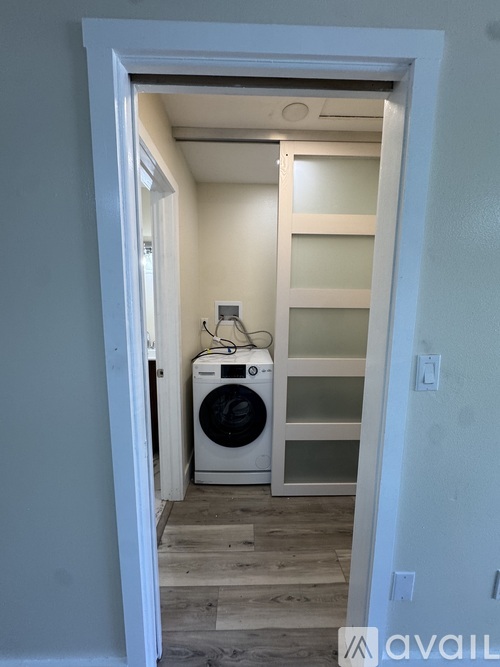 A small laundry room with a washer and dryer.