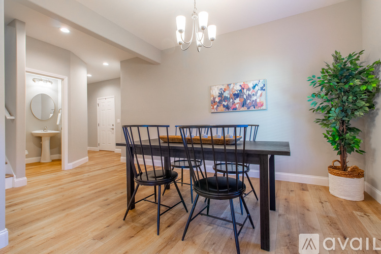 A dining room with a wooden table and chairs.