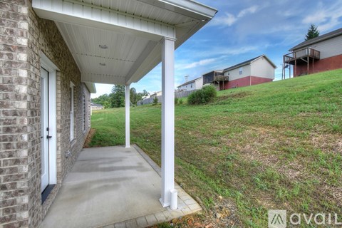 A house with a covered walkway leading to the front door.