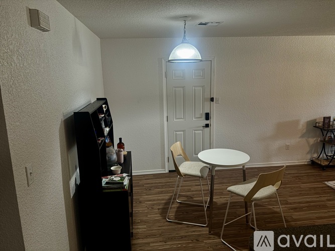 A room with wooden flooring and a ceiling fan.