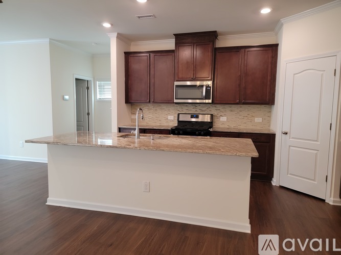 A kitchen with brown cabinets and a granite countertop.