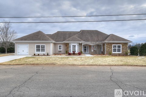 A house with a brown roof and a white garage door is available for sale.