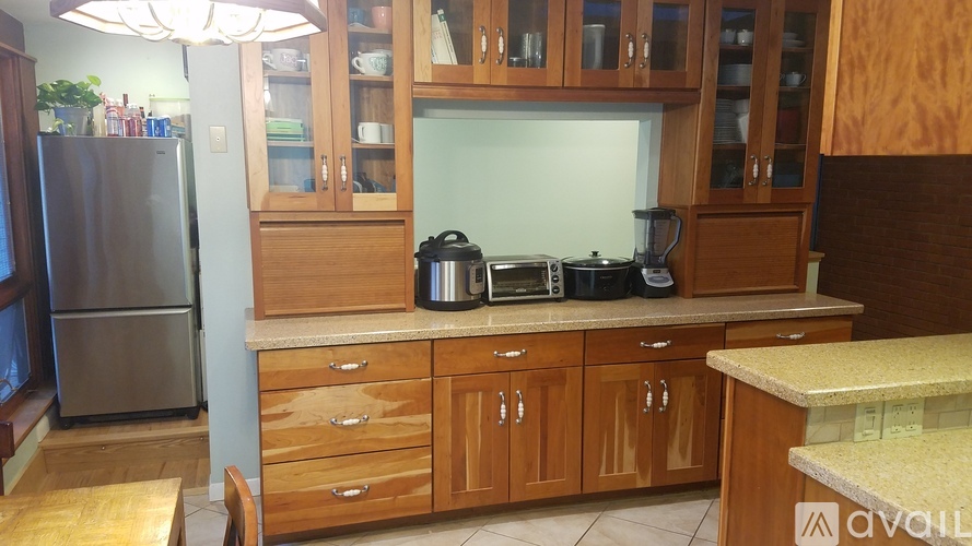 A kitchen with wooden cabinets and a granite counter.