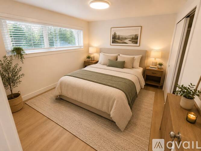 A bedroom with a large bed, a window with blinds, and a painting on the wall.