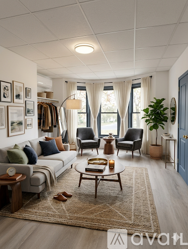 A living room with a couch, chairs, and a rug.