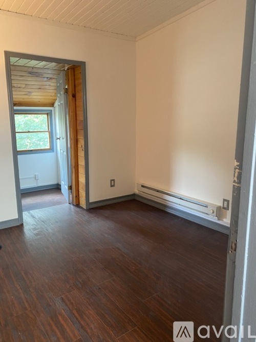 A room with wooden floors and a window.