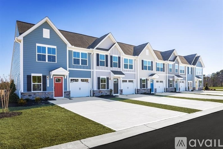A row of houses with the first one having a red door.