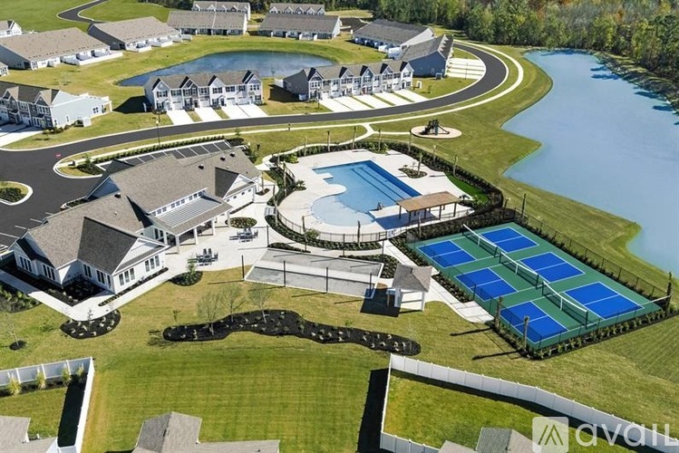 A bird's eye view of a residential area with a swimming pool and solar panels.
