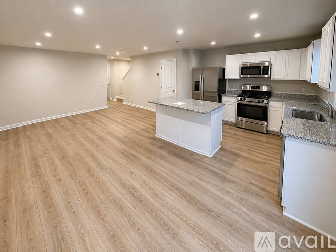 A kitchen with a refrigerator, stove, and oven.