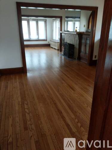 A room with wooden floors and a fireplace.