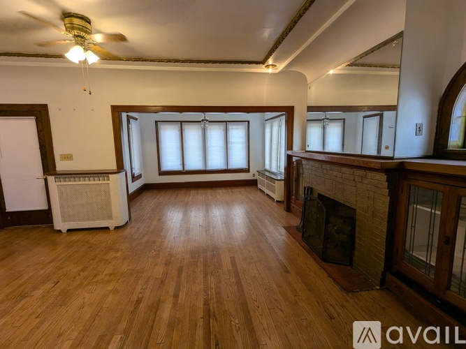 A room with wooden floors and a fireplace.