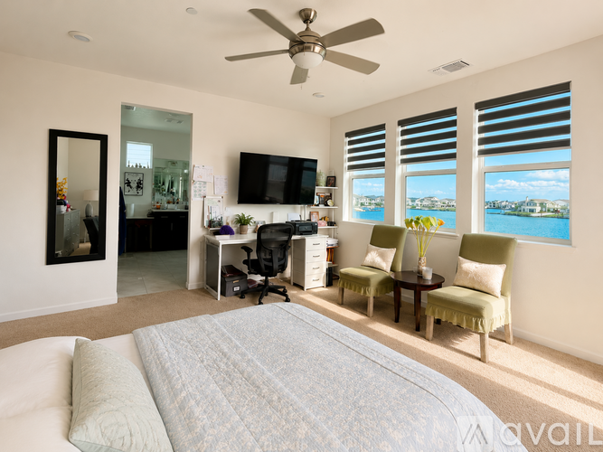 A bedroom with a large bed and a television.