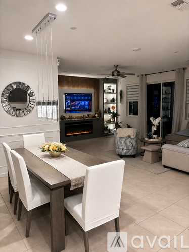 A modern dining room with a wooden table and white chairs.