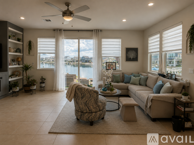 A living room with a large window overlooking a body of water.