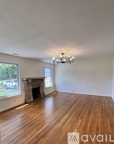 A room with wooden floors and a fireplace.