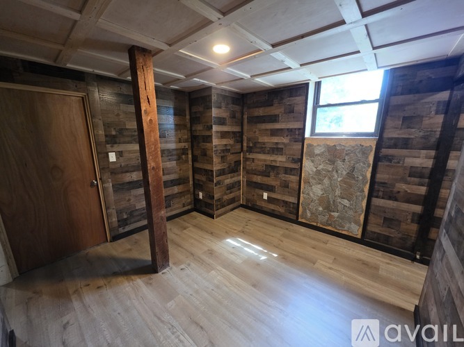 A room with wooden walls and a door.