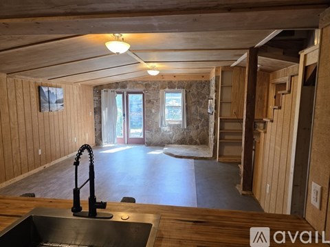 A kitchen with a sink and wooden cabinets.