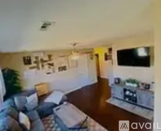 A living room with a couch and a television.