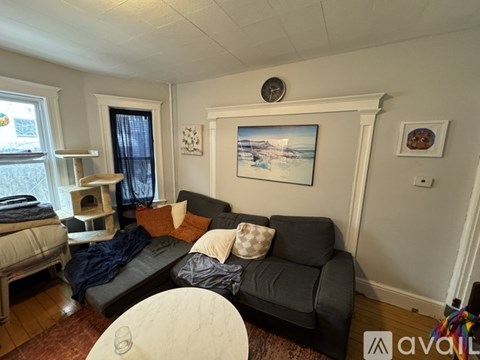 A living room with a grey couch and a white coffee table.