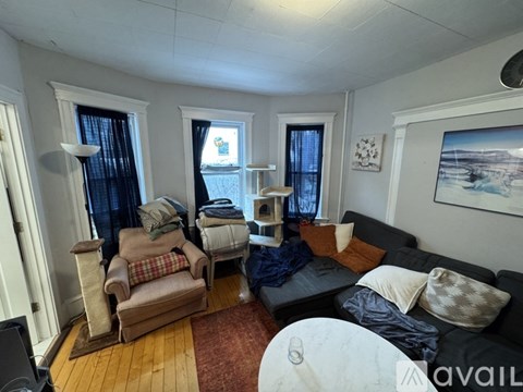 A living room with a couch, chair, and table.