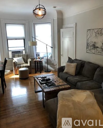 A living room with a grey couch and a coffee table.