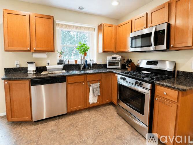 A kitchen with wooden cabinets and stainless steel appliances.