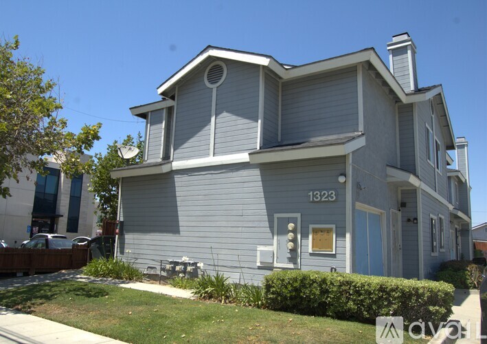 A grey house with the number 1323 on it.