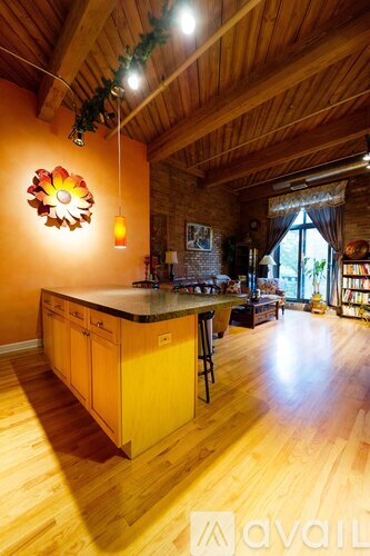 A kitchen with wooden floors and a large island.