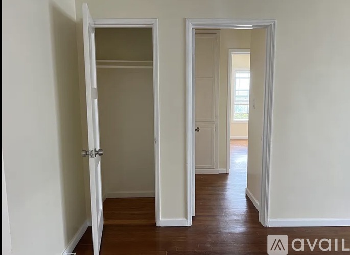 A hallway with two open doors on either side.