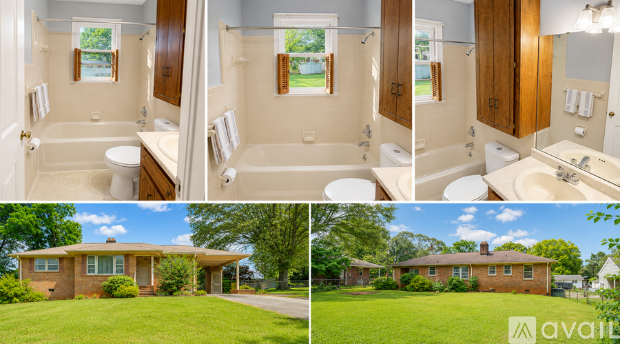 A house with a large bathroom and a green lawn.