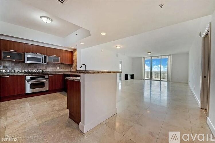 A kitchen with a brown countertop and a white island.