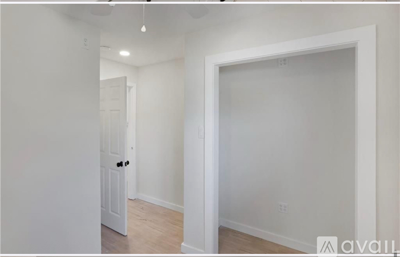 A white door is in a room with white walls.