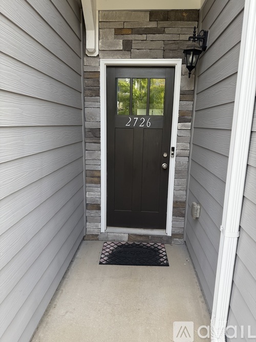 A black door with the number 2726 on it.