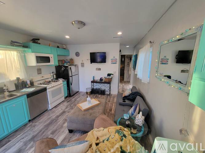 A kitchen with a refrigerator, oven, and microwave.